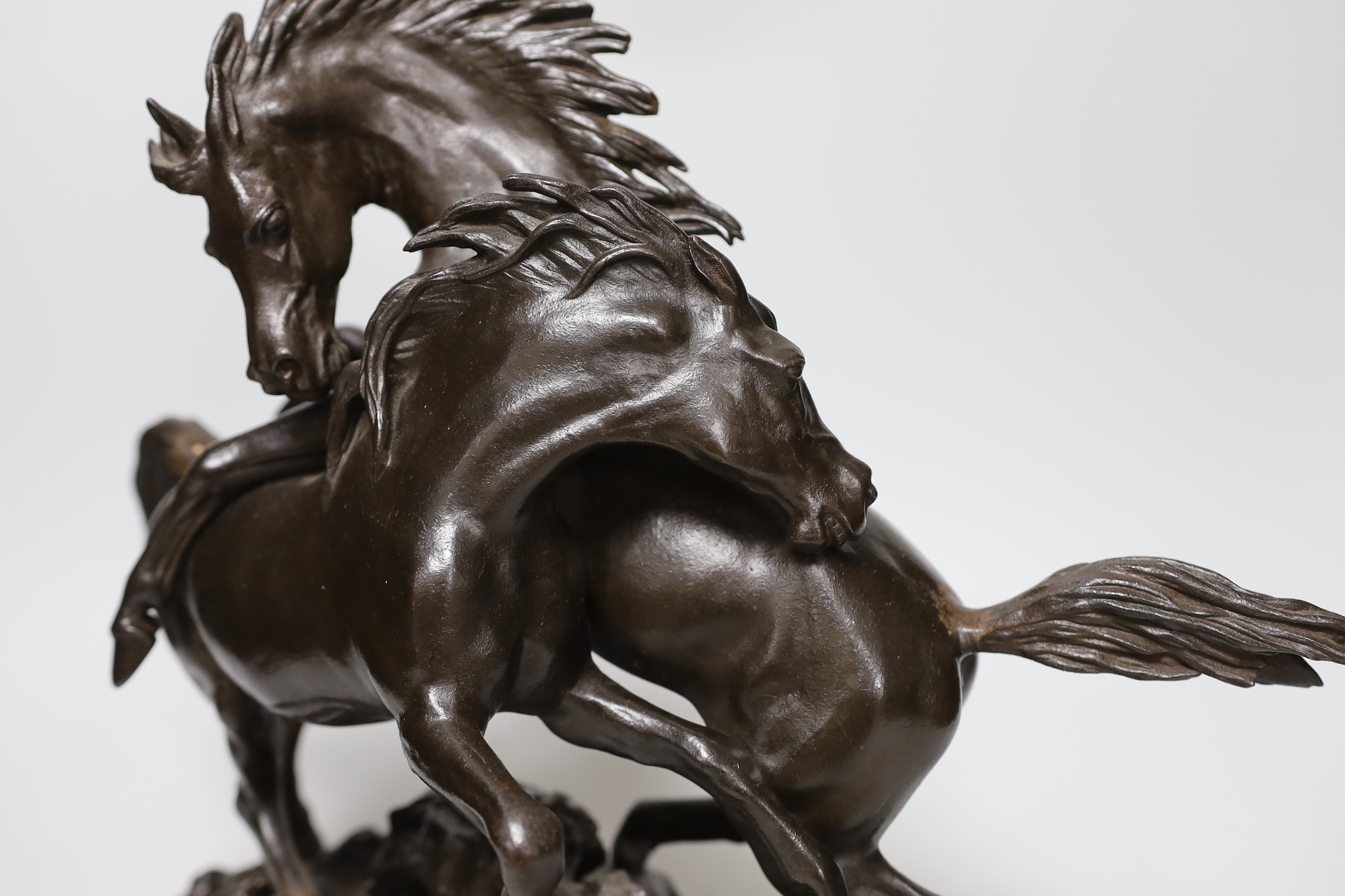 A bronzed cast iron horse group, 35cms high